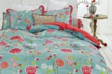 10 blue bedding with red and fuchsia flowers and red ruffles on the pillowcases