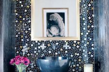 11 mosaic tiles in nvay, blue and gold clad in patterns to highlight the sink zone