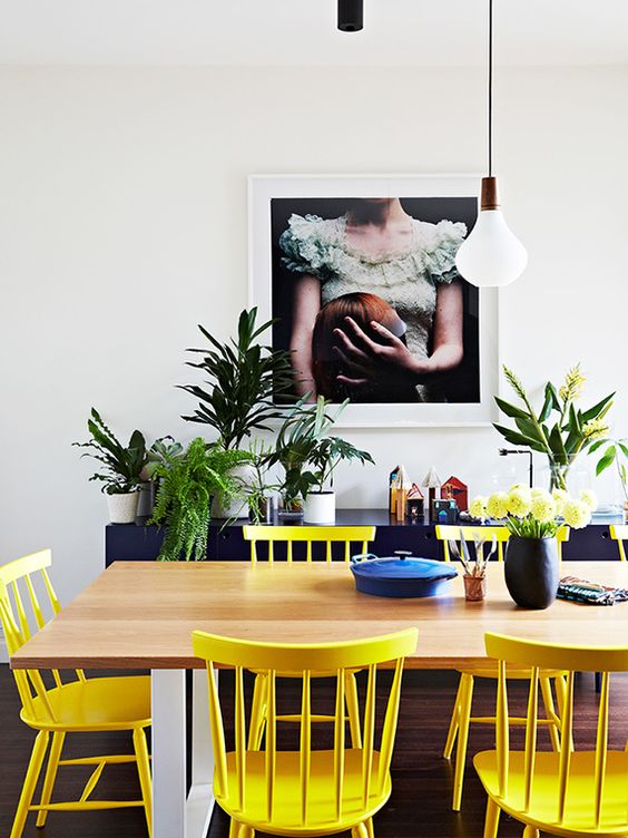 sunny yellow chairs contrast with navy pieces and create a cool mood