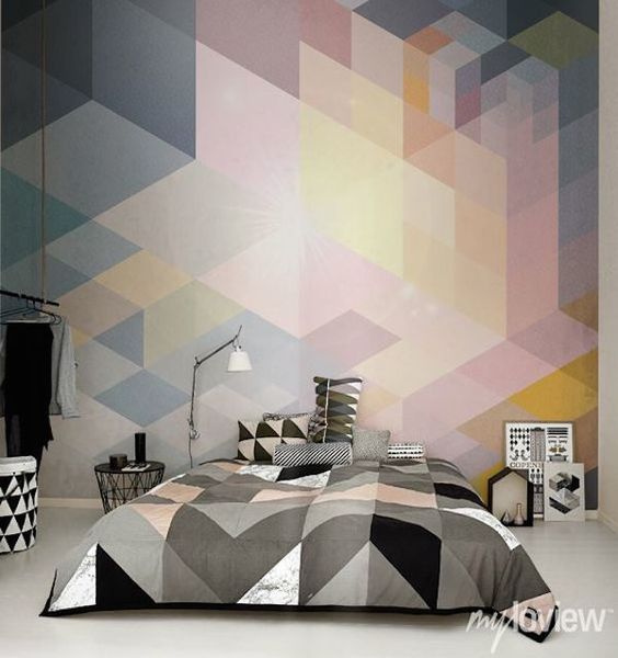 white, grey, black and blush triangle bedding and a matching geo wall mural