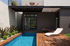 13 a modern wooden deck with a narrow pool and desert plants lining it