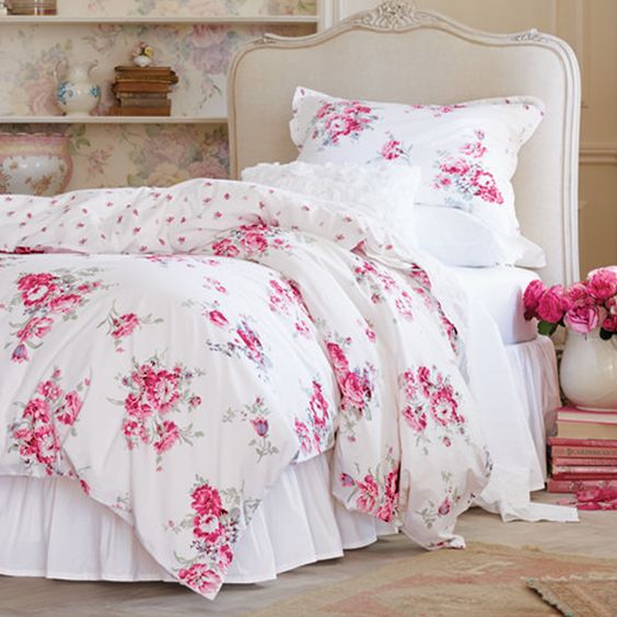 classic white bedding with pink flowers and white ruffled pillowcases