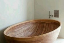 15 a wooden bathtub  of a beautiful half coconut shell shape