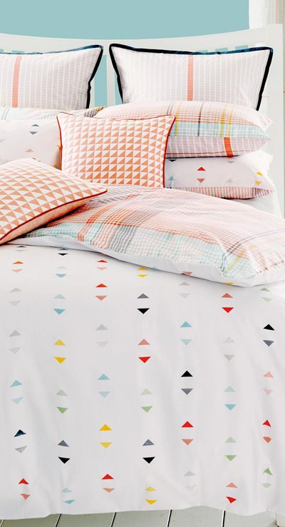pastel checked bedding with colorful triangle prints on the duver and some pillowcases