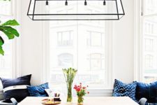 16 a cool black geometric lighting fixture makes a statement in this space