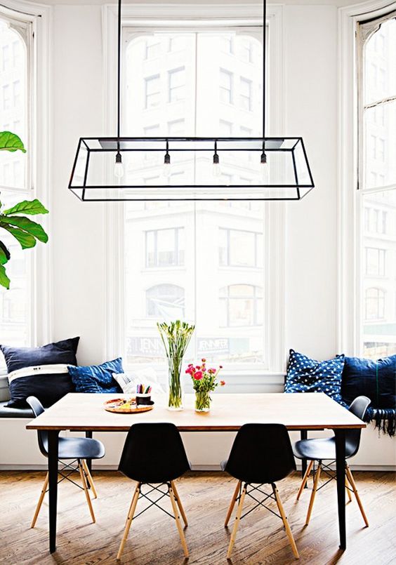 a cool black geometric lighting fixture makes a statement in this space