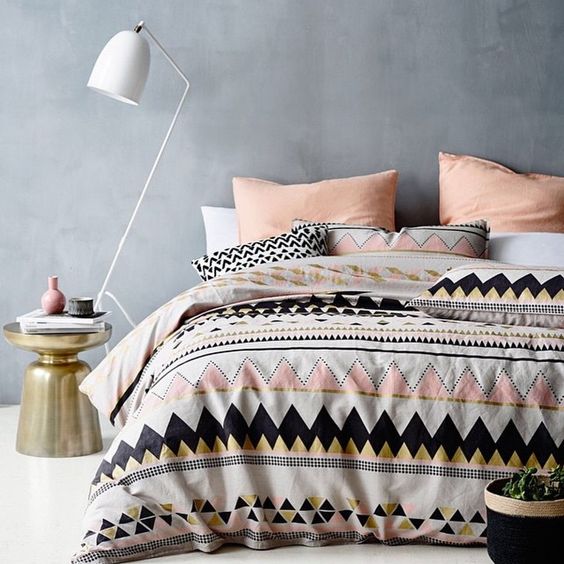 pink, white, black and gold triangle duvet and pillows in the same shades but no prints