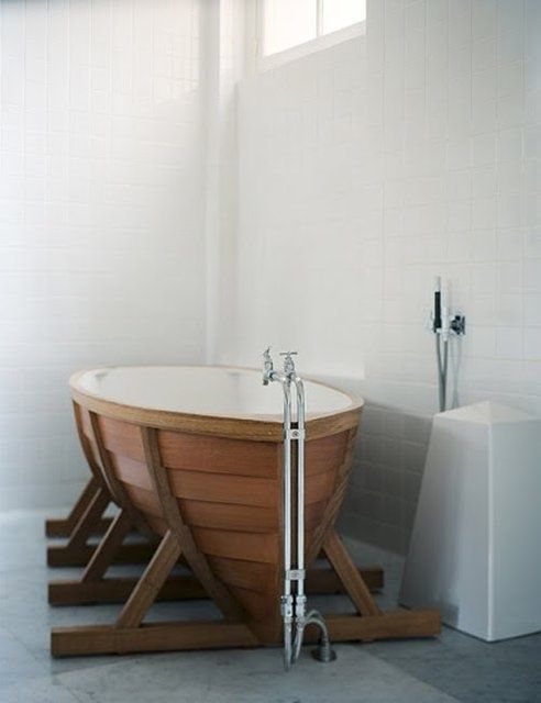 a bathtub that reminds of a boat will be a perfect fit for a seaside bathroom