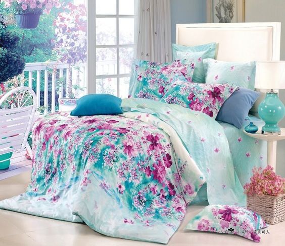 Dreamy aqua colored bedding with pink floral prints looks wow