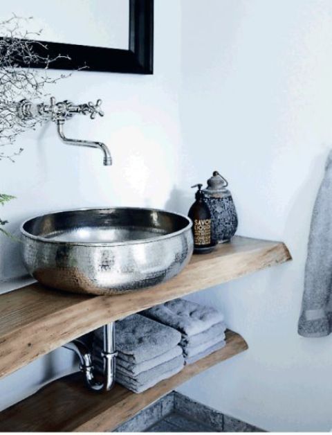 a metal sink and matching hardware contrast with wood