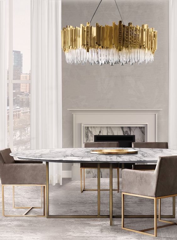 gorgeous oversized glam chandelier echoes with table and chair legs