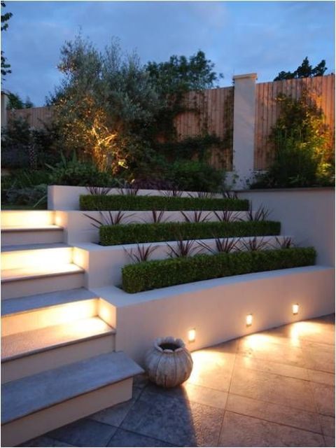 lights attached to the planters to illuminate the patio and steps