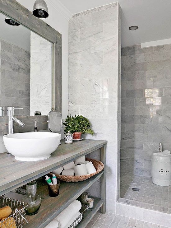 a grey bathroom is enlivened with a single potted plant