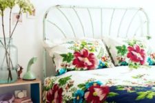 28 vintage-inspired navy and cream bedding with bold turquoise and red flowers on it