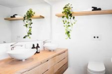 30 a climbing plant adds a natural feel to a laconic modern bathroom