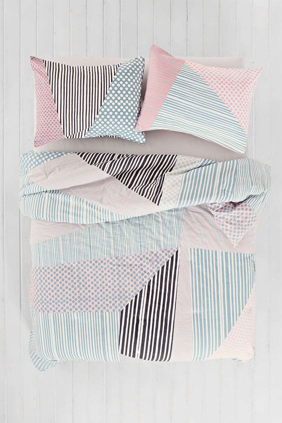pastel blush and blue and black bedding with a graphic print for a girlish space