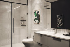 01 This bathroom is done in black and white, with bold green touches and fresh greenery