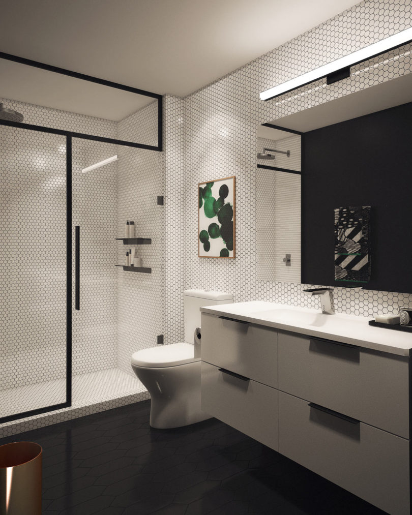 This bathroom is done in black and white, with bold green touches and fresh greenery