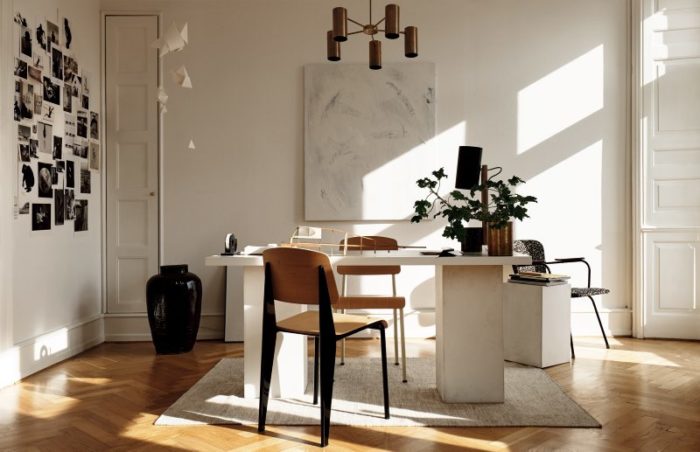 The home office looks like a canvas for all types of creations, and a black and white photo collage inspires the owner
