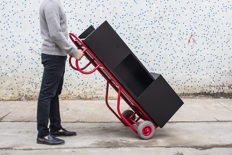 This pushcart furniture piece can be used as a coffee table as well as a bookshelf when upright