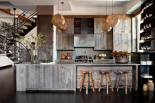04 The kitchen is of weathered wood, with dark metal shelves and rustic wooden stools