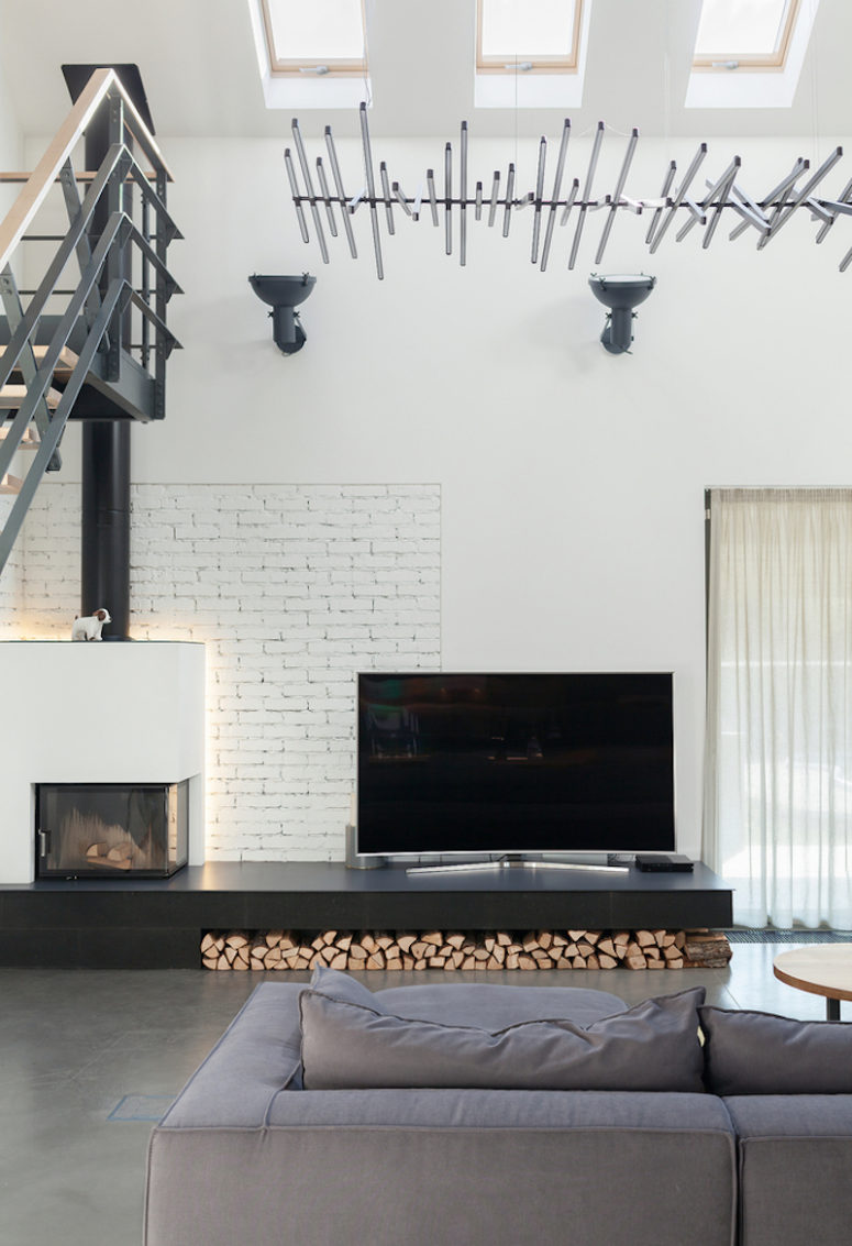 Metal, whitewashed brick, firewood and concrete add texture to the decor