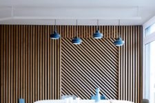 05 wood planks clad in a geometric pattern create bold decor and make the space cool