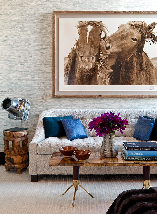 This textural sofa contrasts a stone coffee table and a gorgeous horse photo on the wall