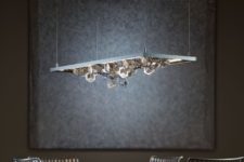 06 Winter pendant features multifaceted polished aluminum snowflakes that create a dramatic display of light and shadow