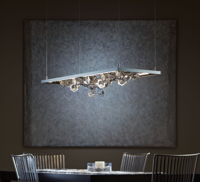 Winter pendant features multifaceted polished aluminum snowflakes that create a dramatic display of light and shadow