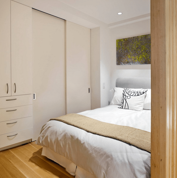There are storage units in the corner of the bedroom drawers and those with sliding doors