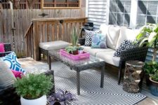 07 colorful outdoor living room on the porch with patterns, prints and potted greenery