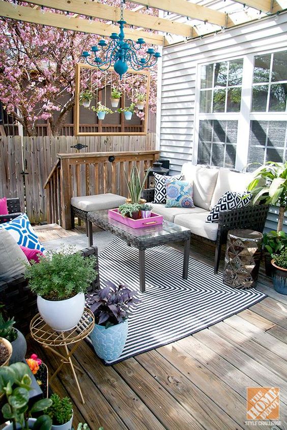 colorful outdoor living room on the porch with patterns, prints and potted greenery