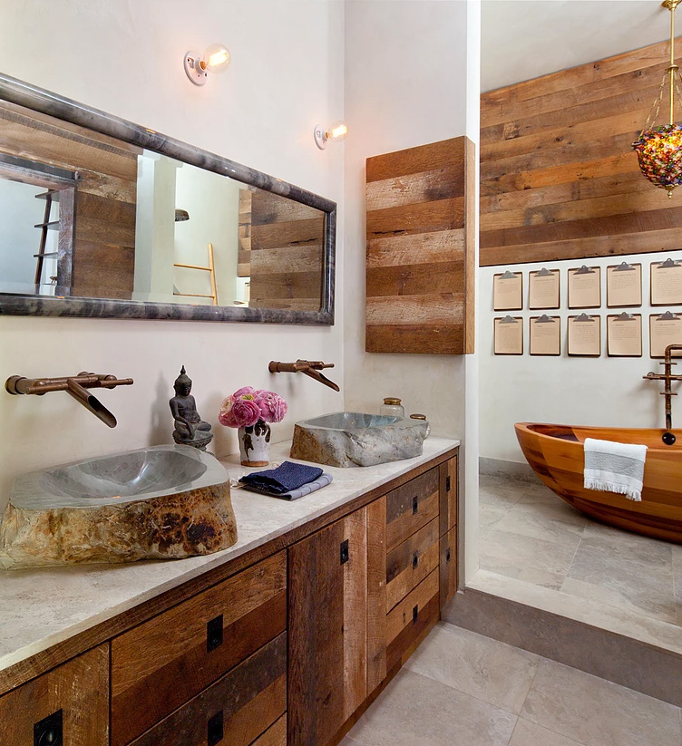 The bathroom features much weathered wood, a wodoen bathtub and stone sinks that catch an eye