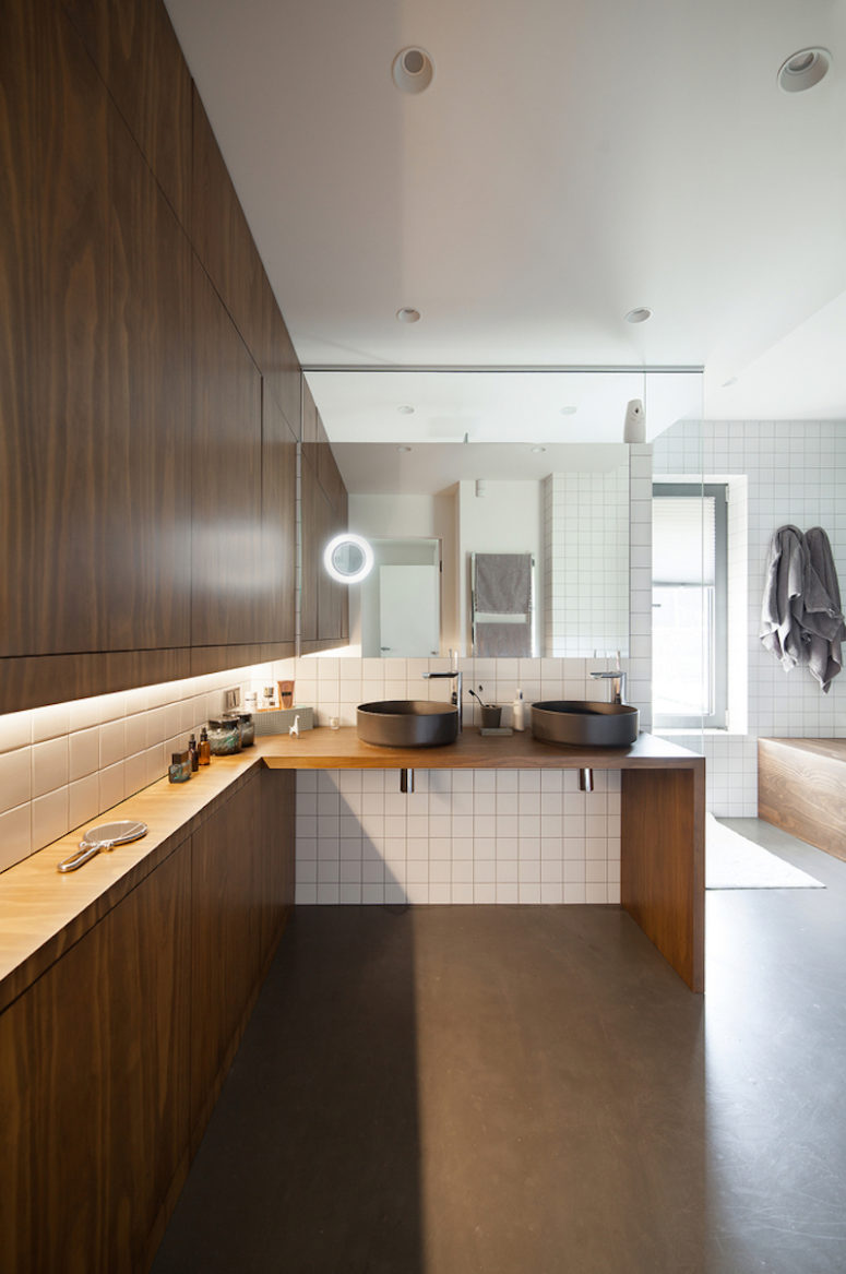 The master bathroom is big and very open, there's a cool wooden countertop with sinks and storage