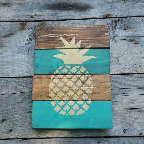 a weathered wood sign with a pineapple made with a stencil is easy