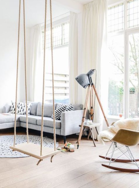 a cozy and light-filled living room with a swing to add a playful and relaxing touch