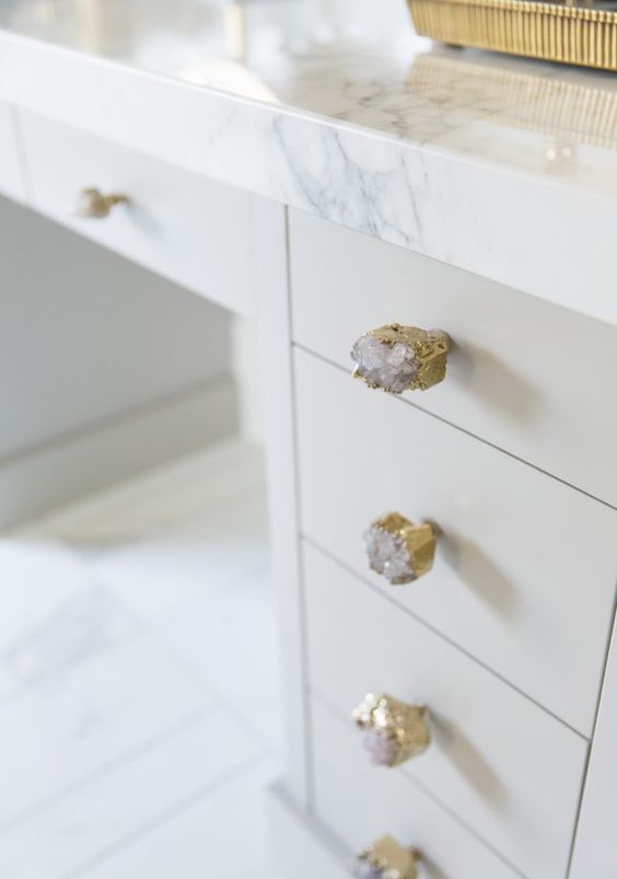 gilded geode knobs and a marble tabletop look very exquisite together