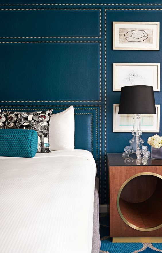 teal wall with decorative nails geo decor looks very chic