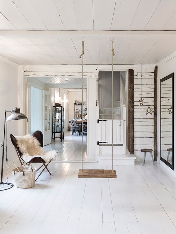 a Scandinavian living room with a swing as a focal point to make it dreamy and relaxing