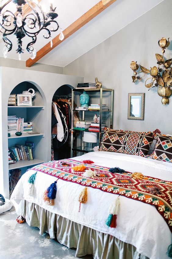 a couple of bold patchwork pillows and a colorful tassel throw can turn your bed into a boho one