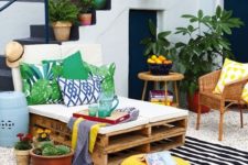 10 bold print pillows and a striped rug add cheer to this outdoor lounge