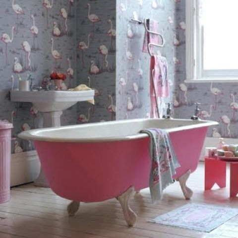 flamingo bathroom wallpaper and a pink bathtub and accessories that highlight it