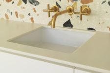 10 white terrazzo with large colored inserts as a backsplash for a white kitchen