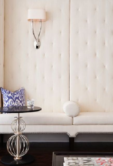 creamy upholstered walls make the space chic, light-filled and absorb the sound
