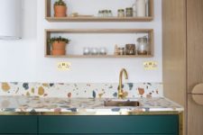 12 a colorful terrazzo kitchen countertop and emerald and gold cabinets look stylish and chic