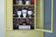12 a light mustard color cupboard with dark floral wallpaper for a contrast