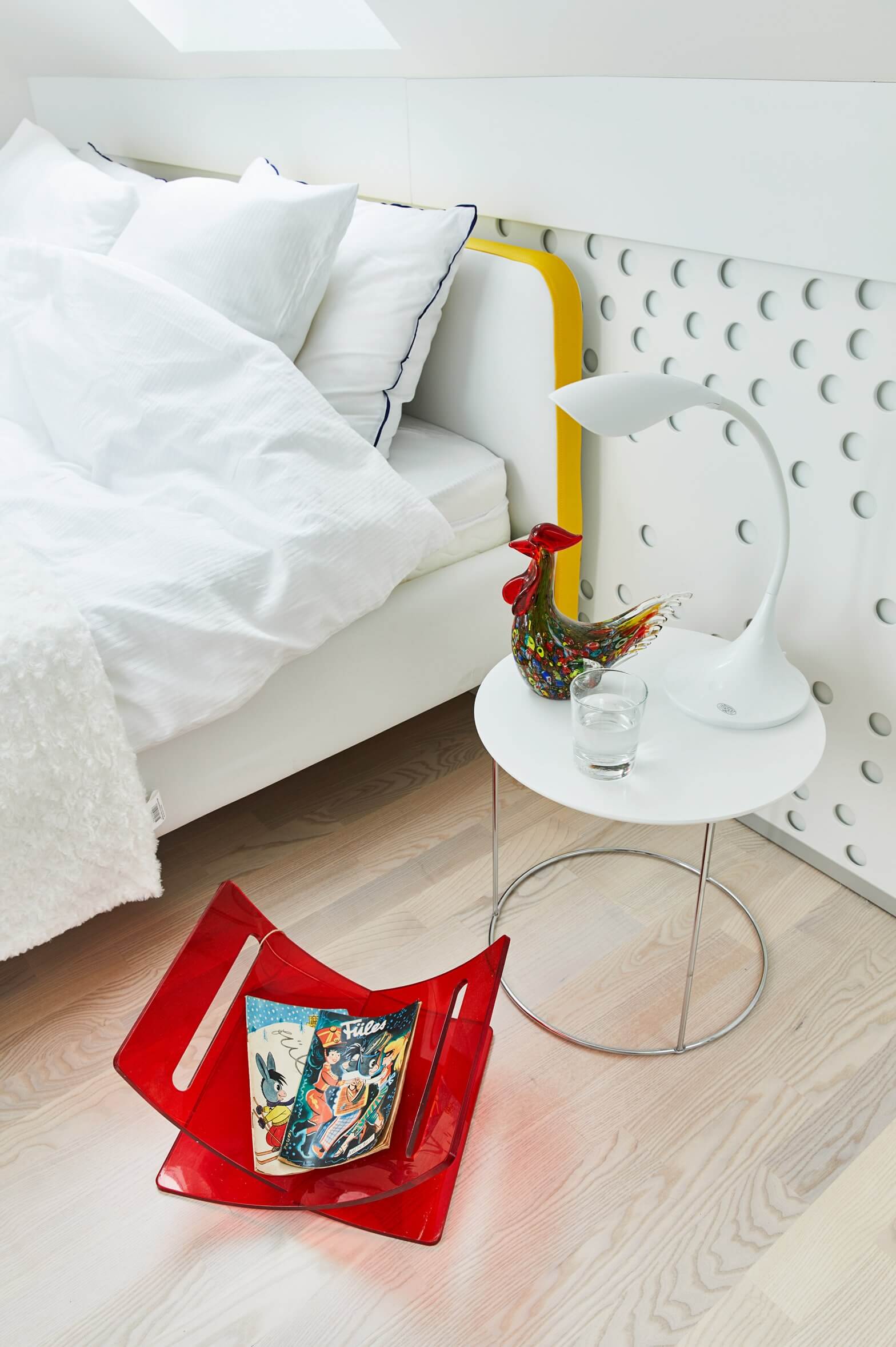 A polka dot wall and a red magazine stand add eye-catchiness to the decor