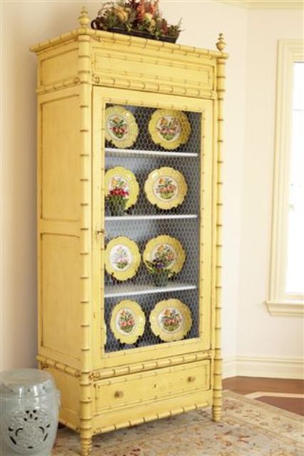 a buttermilk cupboard with chicken wire and yellow dishes on display