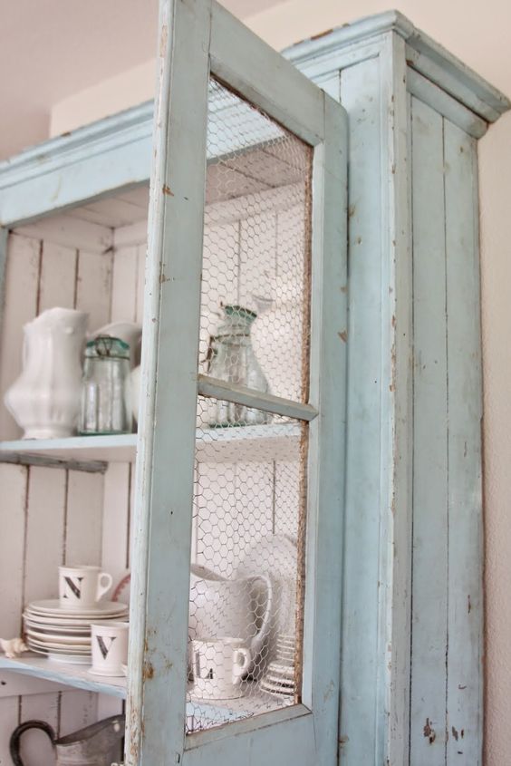 mint cupboard with chicken wire and white paint insde for a contrasting look